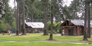 Grassy lawn, trees and picnic shelters at Angle Lake Park.