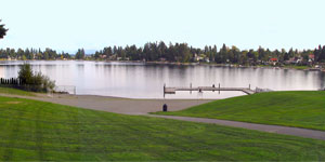 Angle Lake with grassy path and dock in foreground.